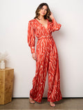 WOMEN'S LONG SLEEVE SURPLICE BELTED PRINT JUMPSUIT